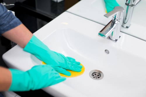 Cleaner using PPE during a risk-assessed cleaning task in Tufnellpark